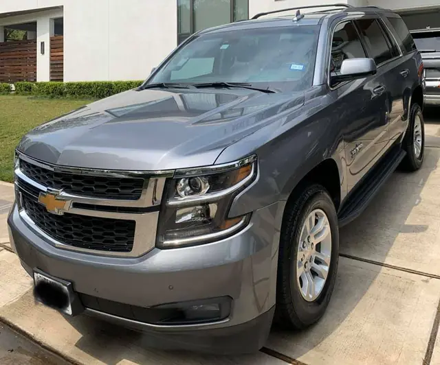 A freshly detailed grey SUV on a modern build driveway in the Houston suburbs